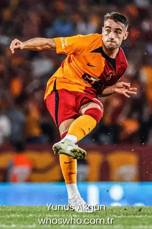 Galatasaray winger Yunus Akgün in action during a football match, striking the ball with his left foot on the pitch.