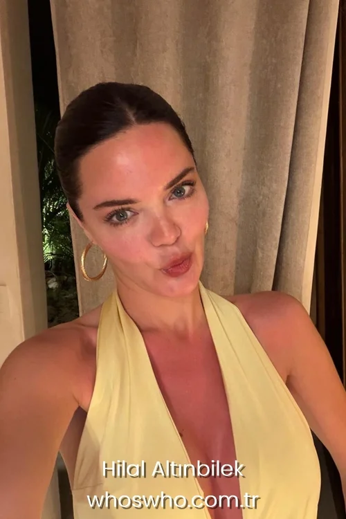 Turkish actress Hilal Altinbilek in a yellow halter neck dress, casual indoor look