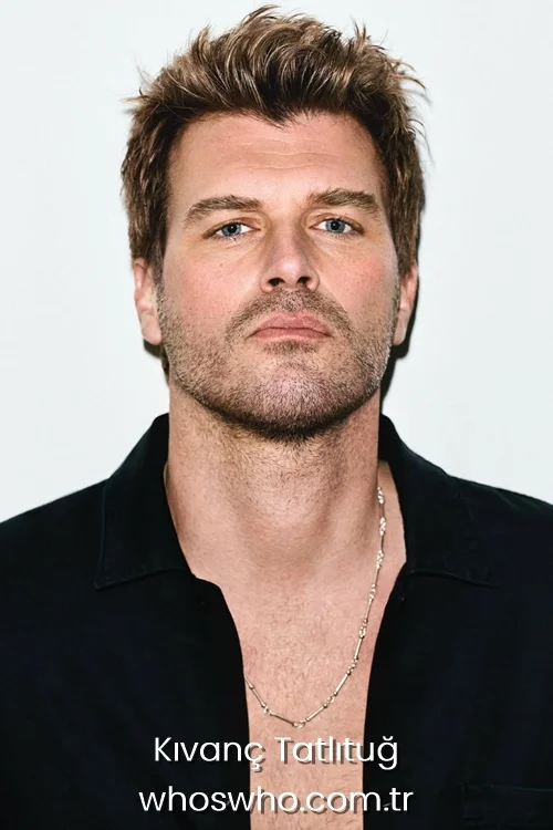 Turkish actor Kivanc Tatlitug wearing a black shirt and a silver chain necklace looking directly at the camera