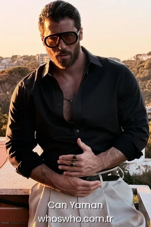 Turkish actor Can Yaman wearing sunglasses and a black shirt posing outdoors during sunset