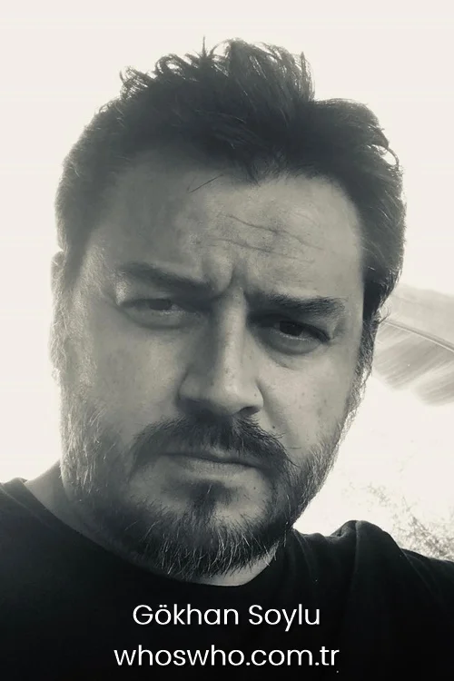 Monochrome close-up portrait of Gökhan Soylu wearing a black t-shirt.