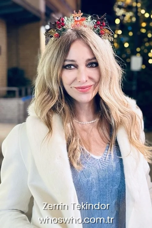 Turkish actress Zerrin Tekindor wearing a Christmas reindeer headband and a white fur collar coat
