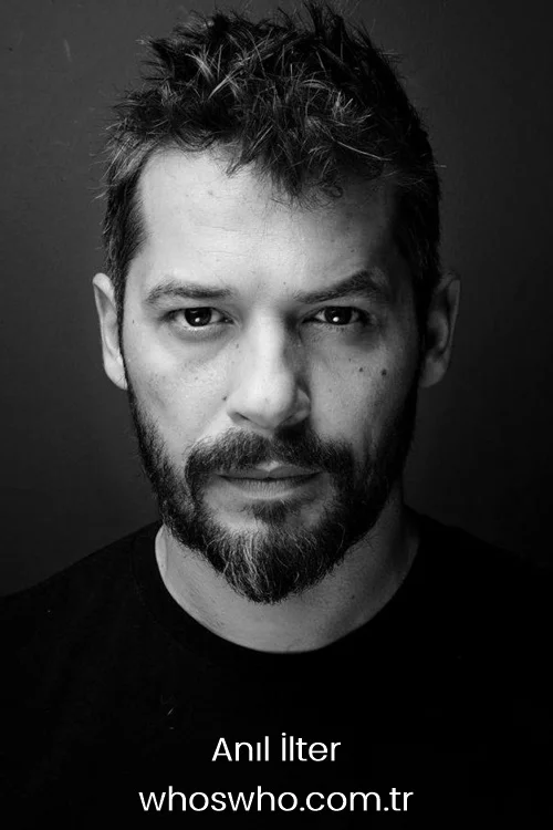 Black and white close up portrait of Turkish actor Anil Ilter looking directly at the camera. 
