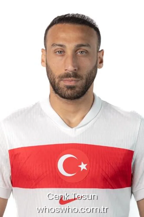 Official studio headshot of Turkish international football player Cenk Tosun with a short beard, wearing the white and red Turkey national team jersey against a plain white background.