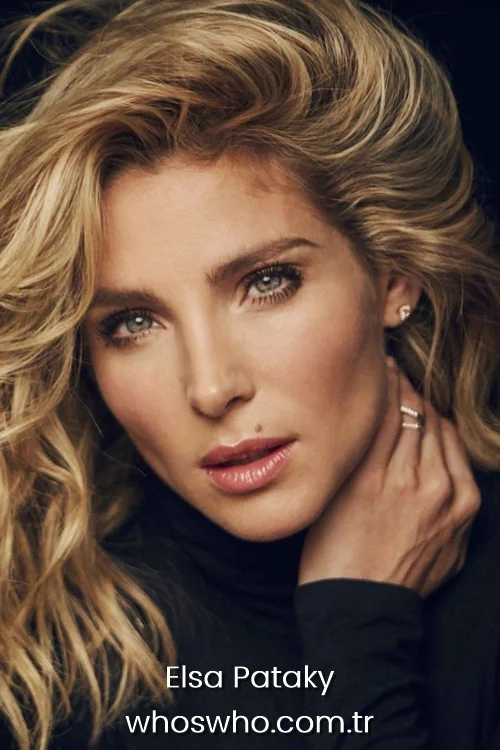 Elsa Pataky looking at the camera with blonde wavy hair and natural makeup.