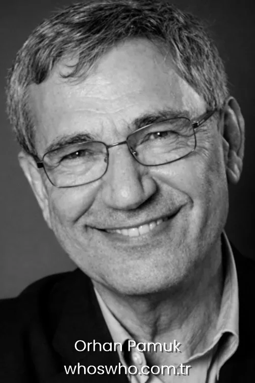Black and white close-up headshot of smiling Turkish author Orhan Pamuk with glasses, looking directly at the camera with a warm, wrinkly smile.