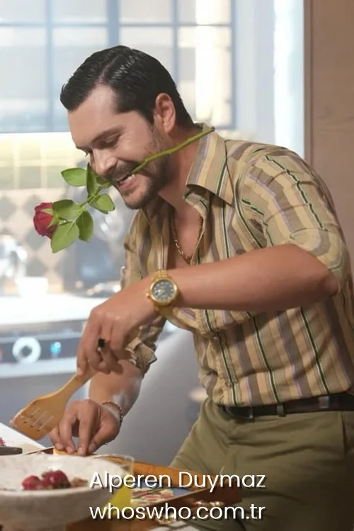 Alperen Duymaz holding a red rose in his mouth while cooking in a striped shirt.
