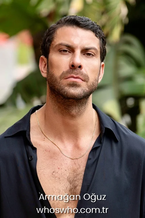 Armagan Oguz close-up portrait wearing a thin gold chain necklace.