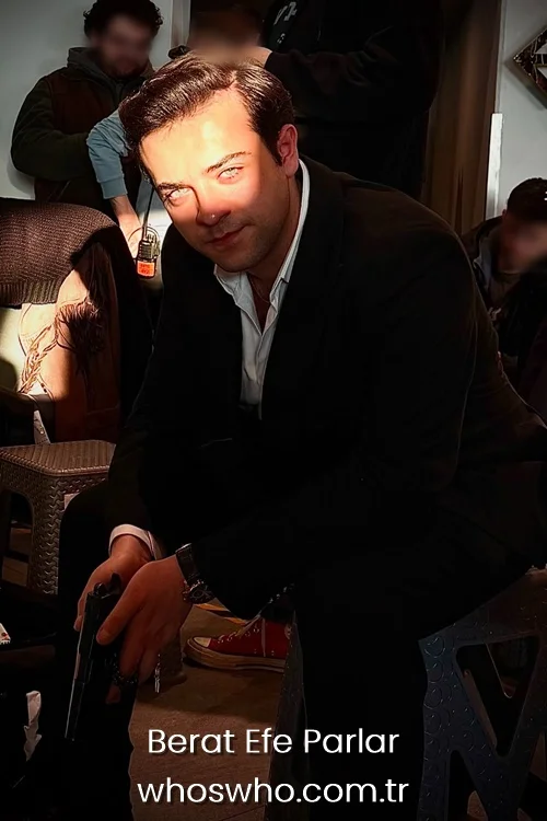Berat Efe Parlar posing in a black suit during a production set.