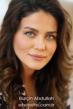 Portrait of Turkish actress Burçin Abdullah smiling at the camera.