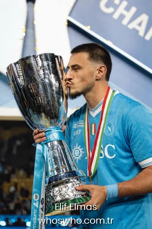 Elif Elmas kissing the Supercoppa Italiana trophy in a blue Napoli jersey.