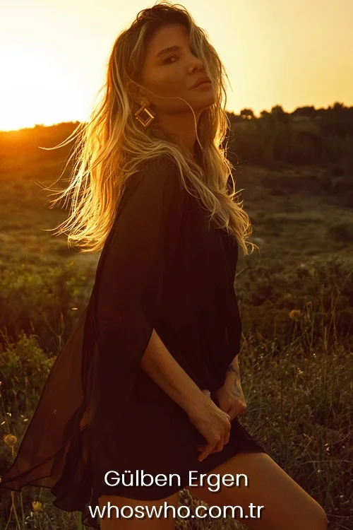Turkish singer Gülben Ergen posing in a flowing black dress at sunset with golden hour lighting.