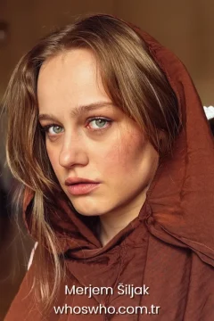 Merjem Šiljak family Biography cover photo of actress Merjem Šiljak wearing a brown hooded garment and showcasing her green eyes.