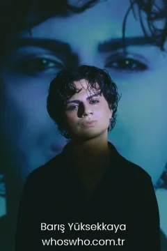 Barış Yüksekkaya weight Official close-up promotional portrait of Crush boy band member Barış Yüksekkaya posing in a black shirt and a silver chain necklace, featuring curly dark hair and looking directly at the camera under dramatic lighting with a large artistic projection of eyes in the blue background.
