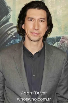 American actor Adam Driver portrait in a gray suit jacket for his official biography profile cover.