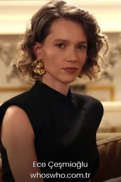 Ece Çeşmioğlu close friends Turkish actress Ece Cesmioglu portrait in a black dress with gold earrings for her official biography profile cover.