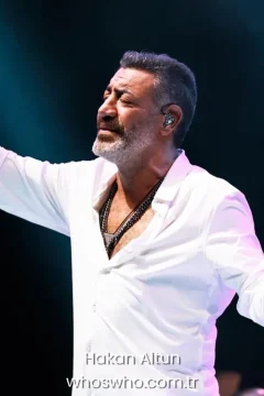 Turkish singer Hakan Altun performing on stage in a white shirt, official biography cover photo