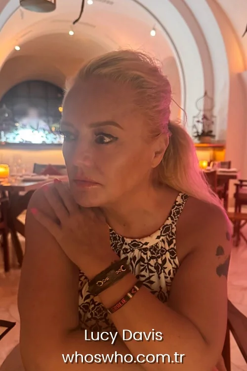 English actress Lucy Davis looking aside in a restaurant, wearing a patterned top
