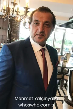 Turkish chef Mehmet Yalcinkaya portrait in a navy blue suit for his official biography profile cover.