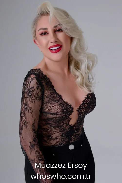 Turkish music icon Muazzez Ersoy wearing a black lace top with red lipstick and wavy blonde hair in a studio glamour portrait 