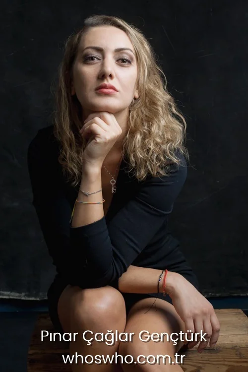 Turkish actress Pinar Caglar Gencturk posing in a black dress, looking directly at the camera