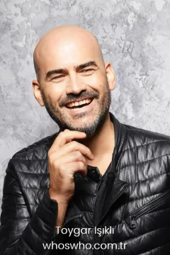 Smiling portrait of Turkish soundtrack composer and singer Toygar Isikli wearing a black quilted leather jacket